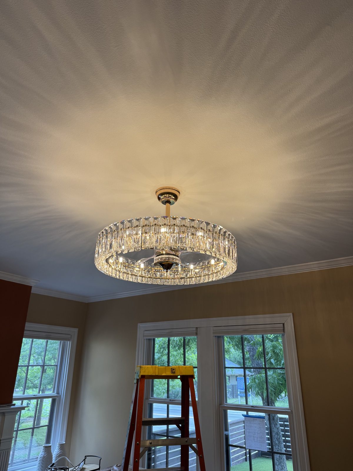 Flush-mount crystal chandelier hung and wired in a two-story foyer.