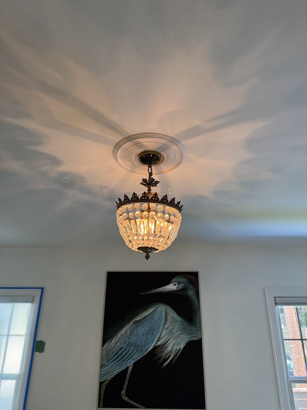 Crystal basket pendant mounted to a plaster ceiling medallion.
